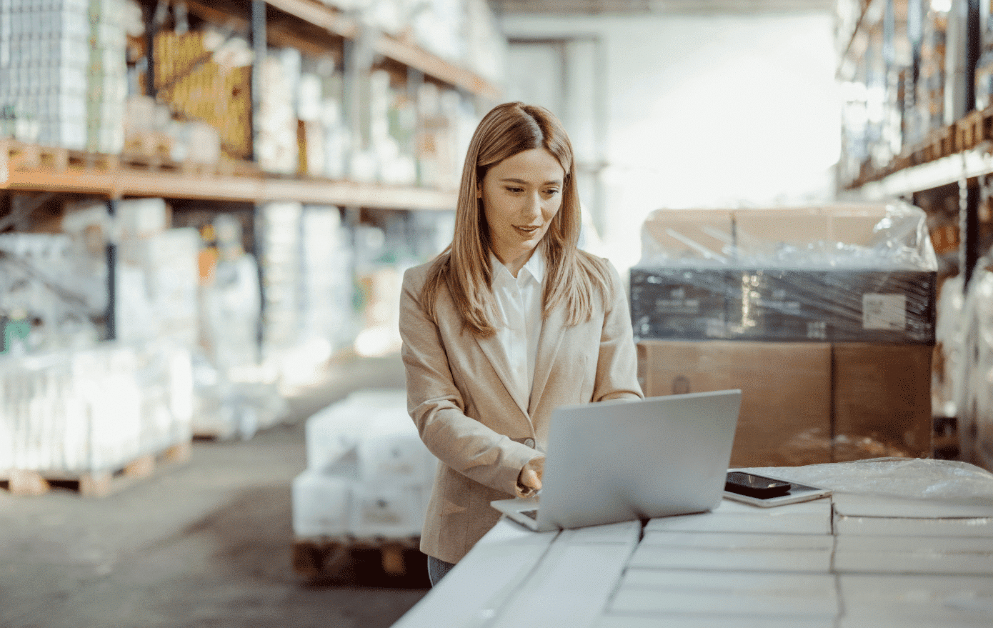 Woman using computer in a warehouse